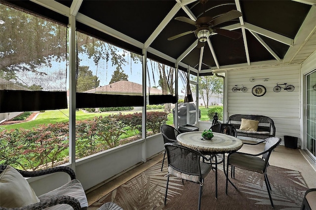 sunroom featuring ceiling fan and plenty of natural light