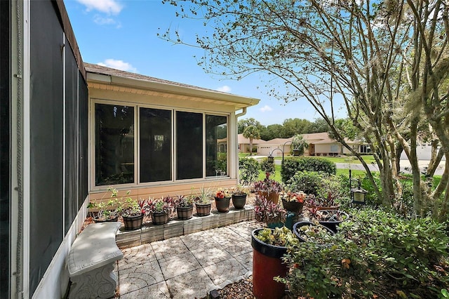 view of patio with a sunroom
