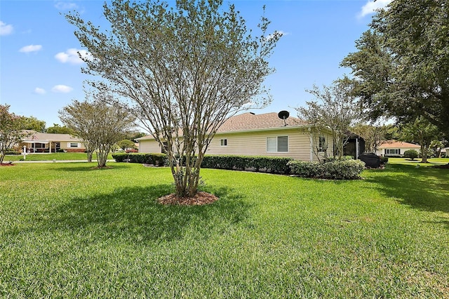 view of side of home featuring a yard