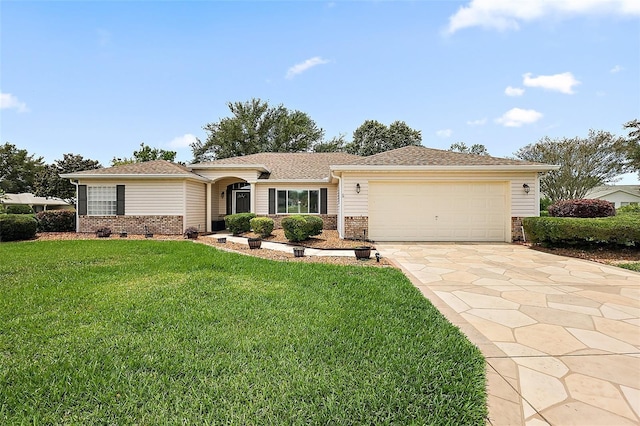 ranch-style house featuring brick siding, an attached garage, driveway, and a front lawn