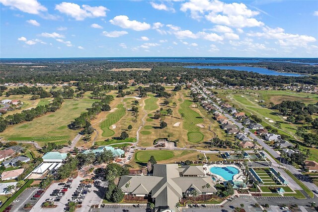 view of property location with a nearby body of water, a local golf course, and a pool area