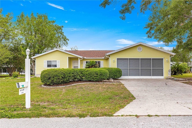 ranch-style home with an attached garage, concrete driveway, and a front lawn