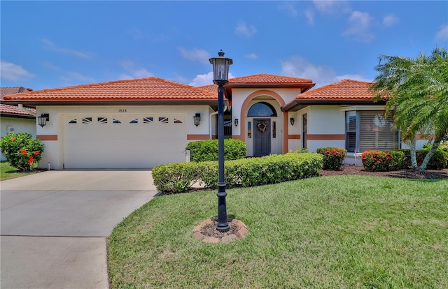 mediterranean / spanish home with a garage, a front lawn, driveway, a tile roof, and stucco siding