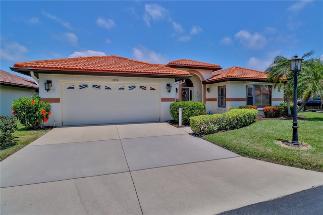mediterranean / spanish-style home with a tile roof, an attached garage, a front lawn, concrete driveway, and stucco siding