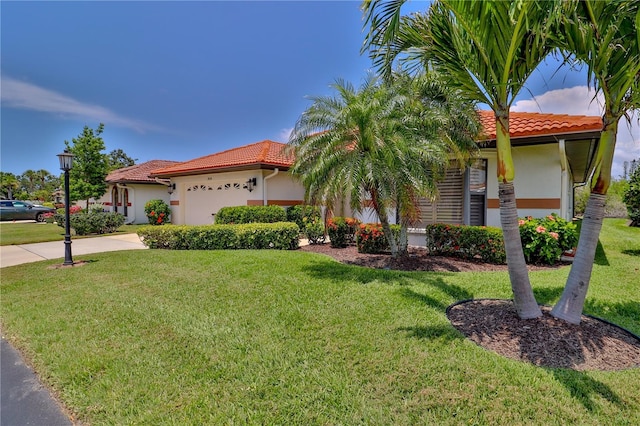 mediterranean / spanish home featuring a tiled roof, stucco siding, an attached garage, and concrete driveway