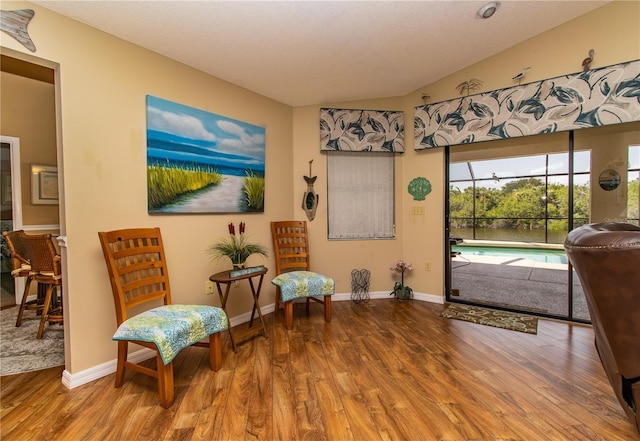 living area with wood finished floors and baseboards