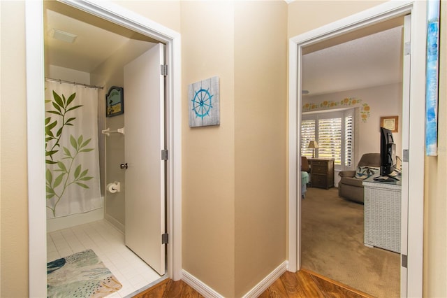hall featuring baseboards