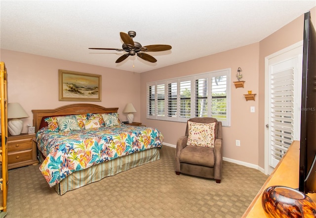 carpeted bedroom with baseboards and ceiling fan
