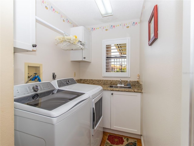 laundry room with washer and clothes dryer, cabinet space, and wood finished floors