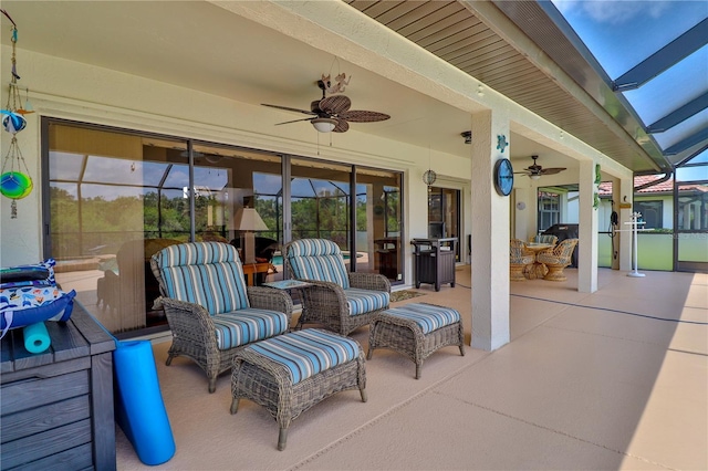view of patio / terrace featuring a ceiling fan, a lanai, and outdoor lounge area