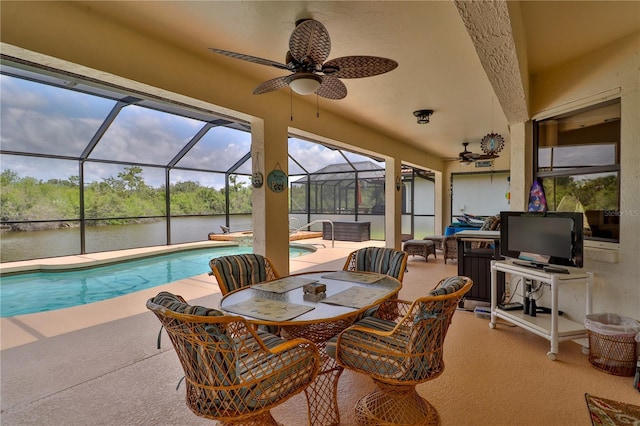 view of patio / terrace with a ceiling fan, a water view, an outdoor pool, and outdoor dining space