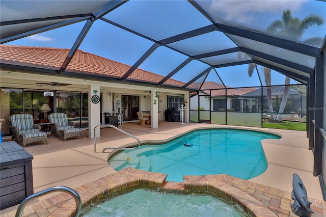 view of swimming pool featuring a patio area, ceiling fan, and a pool with connected hot tub