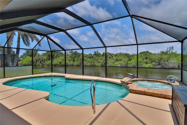 view of swimming pool with a water view, a patio, and a pool with connected hot tub