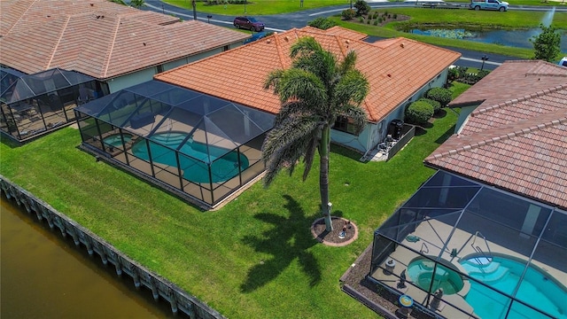 view from above of property with a nearby body of water and a pool