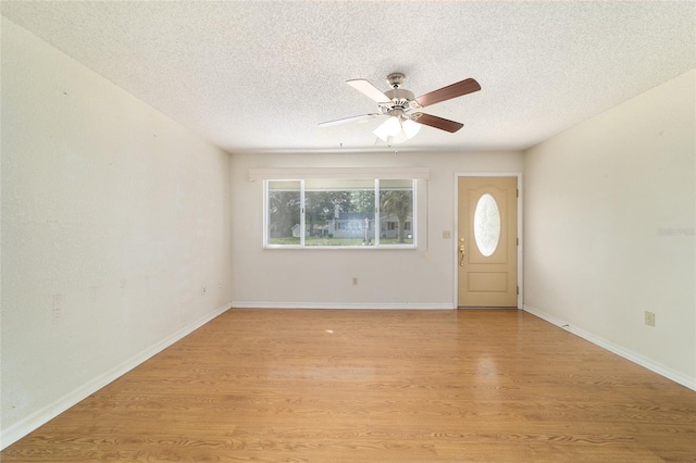 8375 SW 109th Lane Rd, Ocala, FL 34481 - foyer entrance featuring a ceiling fan, a textured ceiling, light wood-style flooring, and baseboards