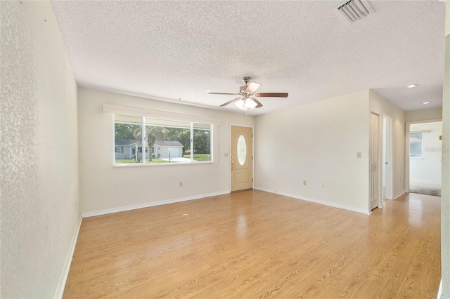 8375 SW 109th Lane Rd, Ocala, FL 34481 - empty room featuring a ceiling fan, light wood-style floors, a textured ceiling, and baseboards