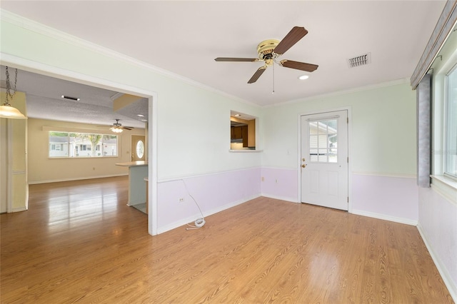 8375 SW 109th Lane Rd, Ocala, FL 34481 - entryway with ceiling fan, wood finished floors, crown molding, and baseboards