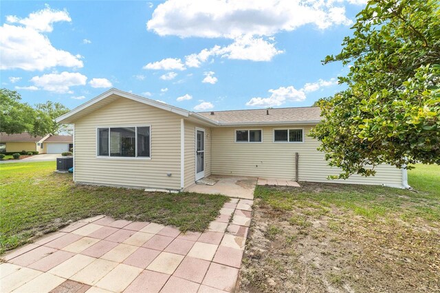 8375 SW 109th Lane Rd, Ocala, FL 34481 - back of property featuring a patio area and a lawn
