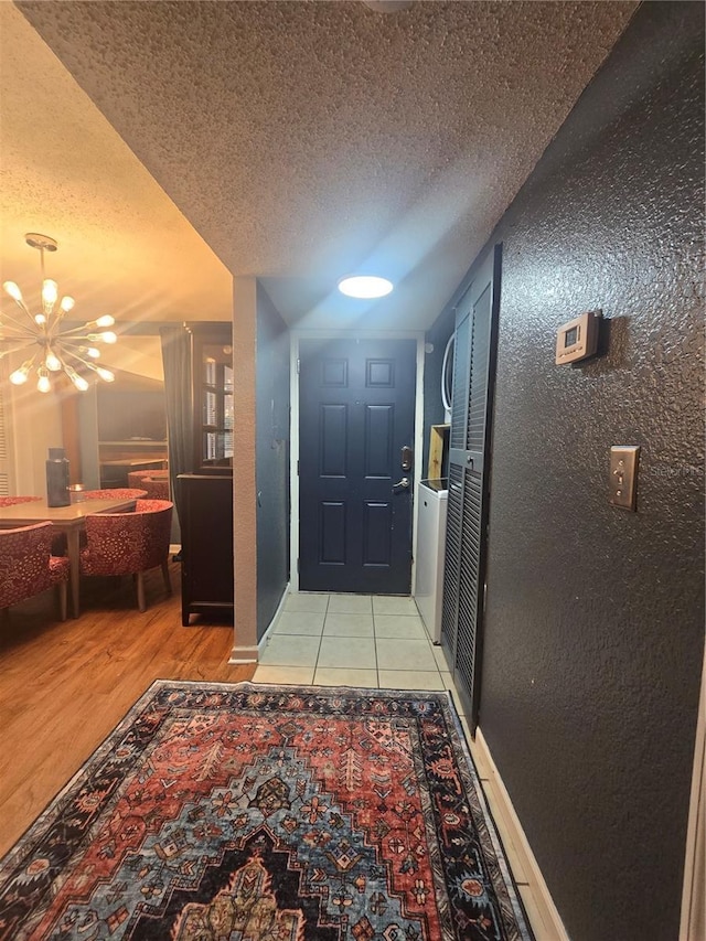 1810 NW 23rd Blvd Unit 230A, Gainesville, FL 32605 - hall with a textured ceiling, a chandelier, and light wood-style floors