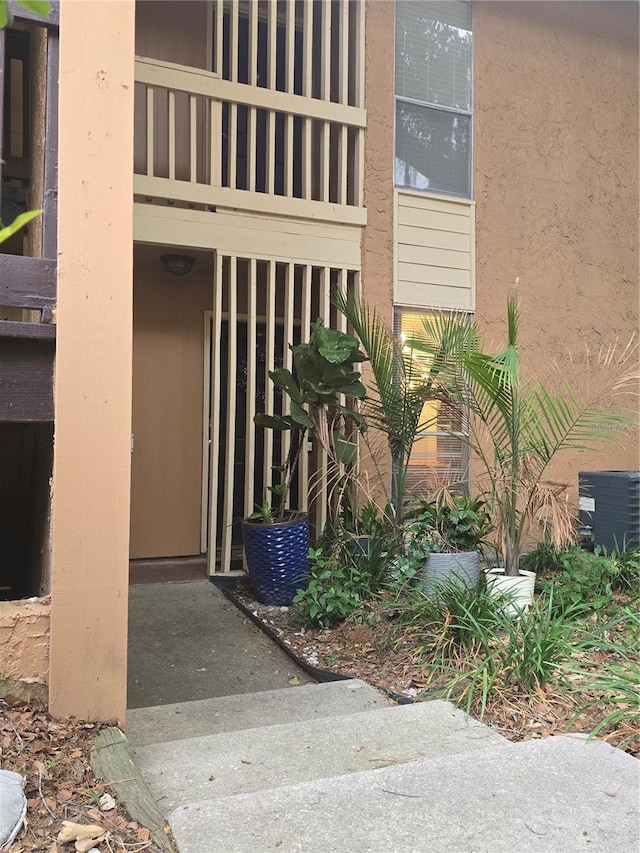 1810 NW 23rd Blvd Unit 230A, Gainesville, FL 32605 - entrance to property with cooling unit, a balcony, and stucco siding