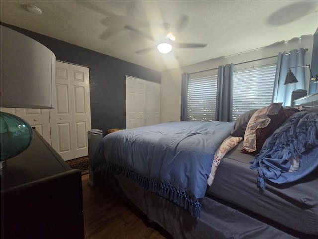 1810 NW 23rd Blvd Unit 230A, Gainesville, FL 32605 - bedroom featuring wood finished floors, two closets, and a ceiling fan
