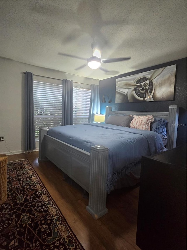 1810 NW 23rd Blvd Unit 230A, Gainesville, FL 32605 - bedroom with a textured ceiling, dark wood-style flooring, and ceiling fan