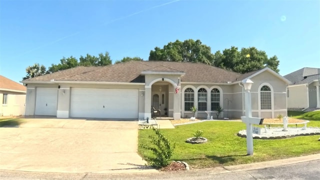 5340 NW 26th Ln, Ocala, FL 34482 - ranch-style home featuring an attached garage, driveway, a front lawn, stucco siding, and a shingled roof