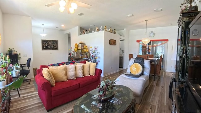 5340 NW 26th Ln, Ocala, FL 34482 - living area with wood finished floors, ceiling fan, a chandelier, and baseboards