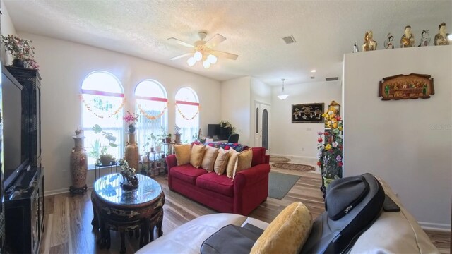 5340 NW 26th Ln, Ocala, FL 34482 - living area featuring wood finished floors, a ceiling fan, baseboards, and a textured ceiling