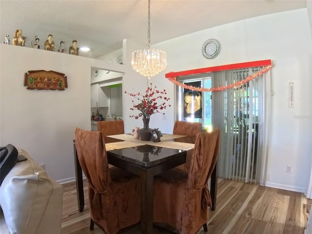 5340 NW 26th Ln, Ocala, FL 34482 - dining space featuring a chandelier, wood finished floors, and baseboards
