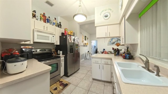 5340 NW 26th Ln, Ocala, FL 34482 - kitchen with appliances with stainless steel finishes, a sink, light countertops, and white cabinetry