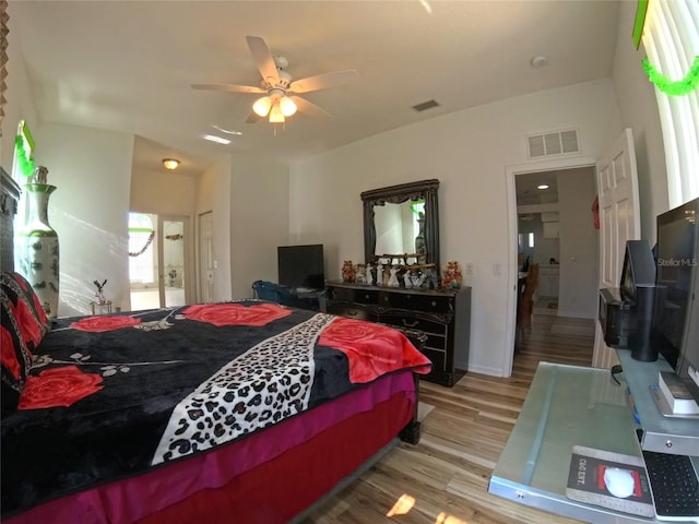 5340 NW 26th Ln, Ocala, FL 34482 - bedroom featuring wood finished floors, a ceiling fan, and ensuite bath