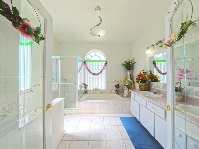 5340 NW 26th Ln, Ocala, FL 34482 - bathroom featuring vanity, a shower stall, a garden tub, and tile patterned floors