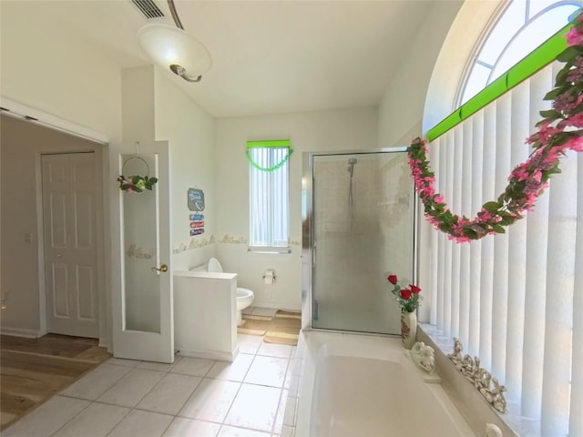 5340 NW 26th Ln, Ocala, FL 34482 - full bath featuring tile patterned flooring, a bath, a shower stall, and toilet