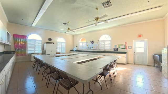5340 NW 26th Ln, Ocala, FL 34482 - kitchen featuring ceiling fan, light tile patterned floors, white cabinetry, baseboards, and crown molding