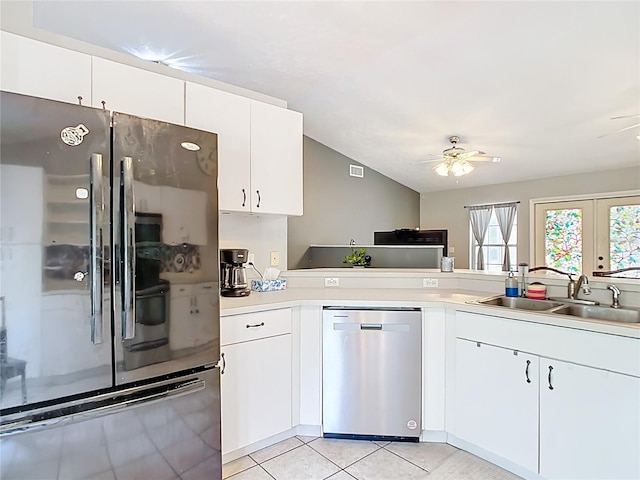 kitchen featuring appliances with stainless steel finishes, a sink, ceiling fan, light countertops, and light tile patterned floors