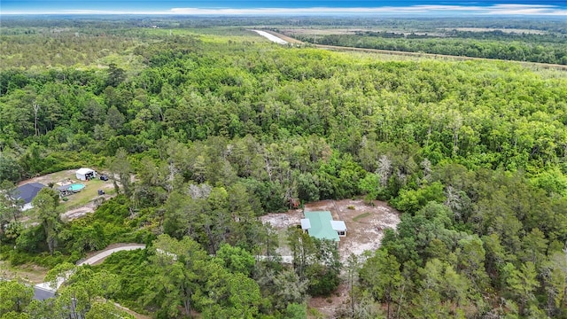 aerial view of property's location with a heavily wooded area