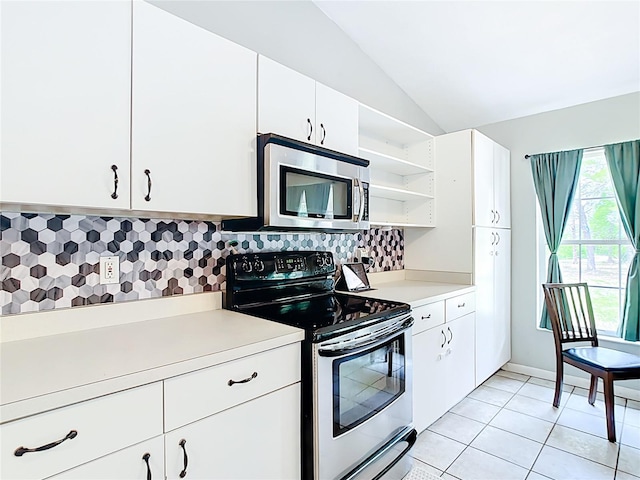 kitchen featuring appliances with stainless steel finishes, light countertops, open shelves, lofted ceiling, and tasteful backsplash
