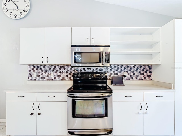 kitchen featuring appliances with stainless steel finishes, open shelves, light countertops, and backsplash