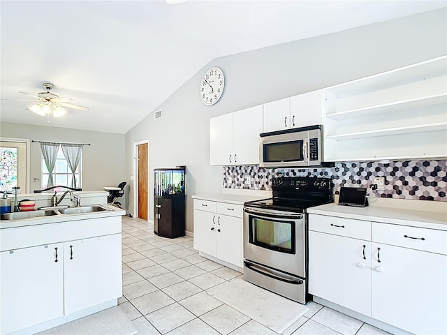 kitchen with stainless steel appliances, a sink, open shelves, lofted ceiling, and decorative backsplash