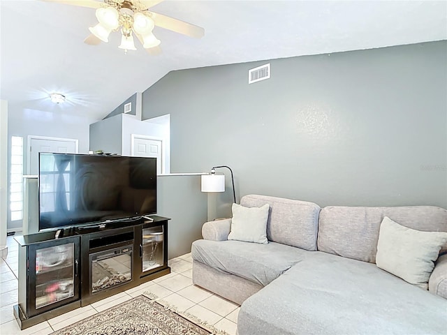 living area with vaulted ceiling, ceiling fan, and tile patterned flooring