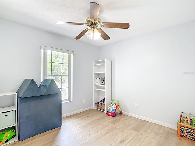 game room featuring wood finished floors, baseboards, and ceiling fan