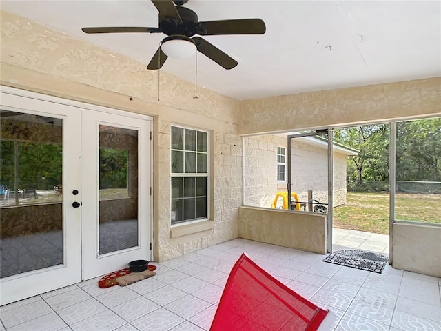 sunroom / solarium with french doors and ceiling fan