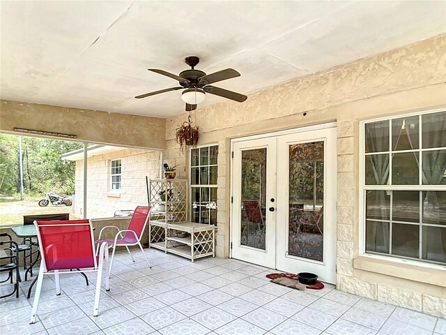 sunroom with french doors and ceiling fan