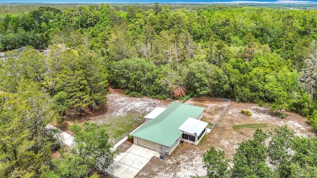view of subject property featuring a heavily wooded area