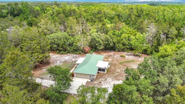 view from above of property featuring a heavily wooded area