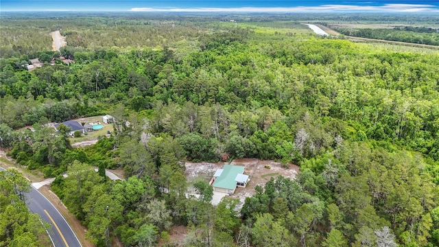 view of property location with a heavily wooded area