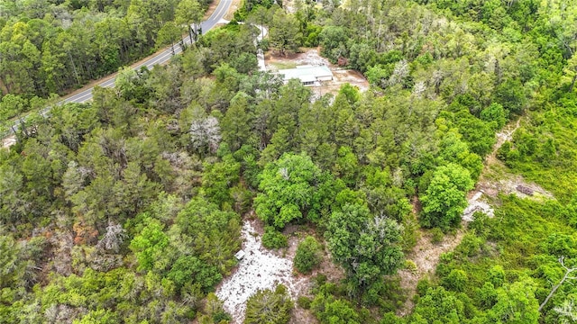 aerial view of property's location with a heavily wooded area