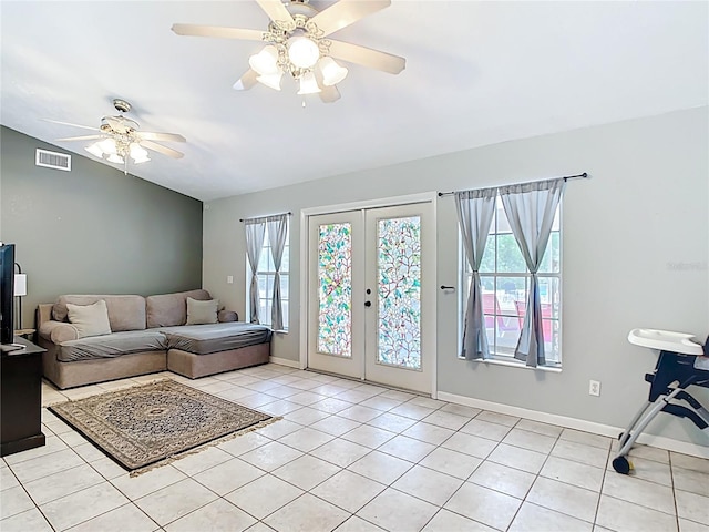 living room with light tile patterned flooring, ceiling fan, french doors, and baseboards