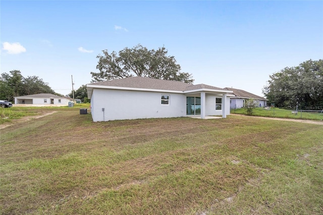 9731 Bahia Rd, Ocala, FL 34472 - back of house featuring a lawn and stucco siding